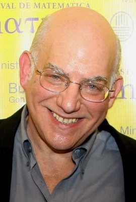 Bold man, age 61, with glasses giving a broad smile
