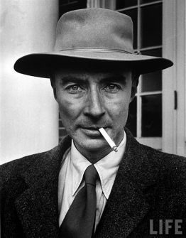 Intense angular face with pork-pie hat and burning cigarette